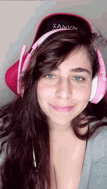 a woman wearing headphones and a hat with xamv written on it