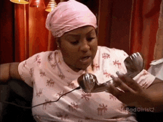 a woman in a pink head scarf is talking on a phone