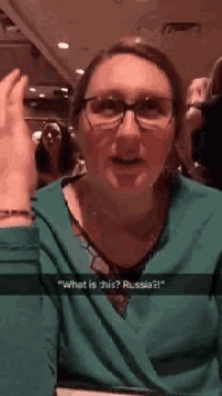 a woman wearing glasses and a green shirt says " what is this russia ? "
