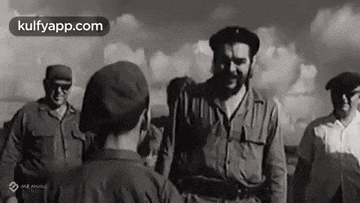 a group of men are standing next to each other in a field .
