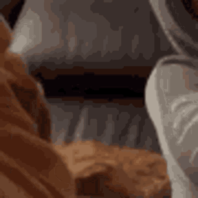 a close up of a person 's feet and a cat on a couch .