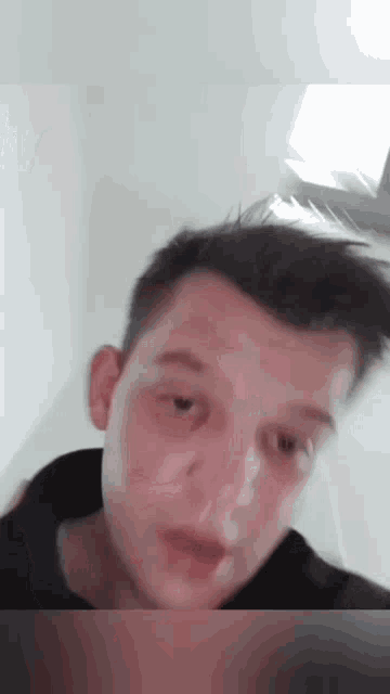 a close up of a young man 's face with a blurred background