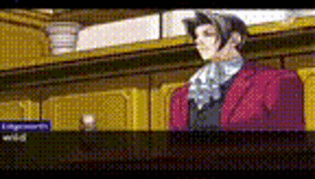 a man in a red suit and tie is standing in a room .