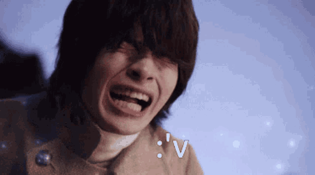 a close up of a person 's face with a smiley face and the letter v