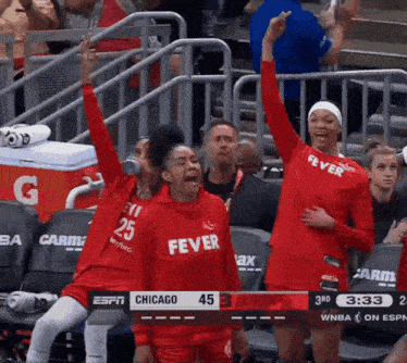 a group of female basketball players wearing red shirts that say fever on them