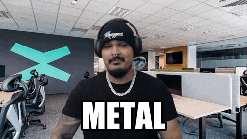 a man is wearing headphones and a black shirt that says metal