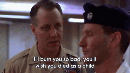 a man in a military uniform is talking to another man