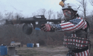 a man in an american flag outfit holds a gun
