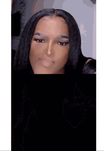 a woman with long black hair is making a funny face with her eyes closed .