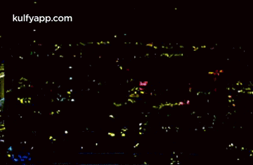 a picture of a city at night with the words kulfyapp.com on the bottom right