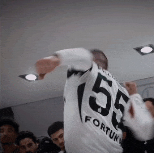 a man wearing a jersey that says 55 fortune on it