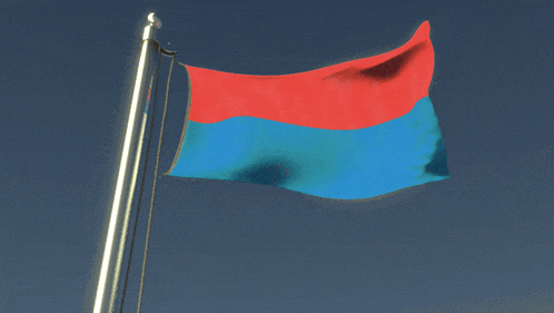 a red and blue flag is waving in the wind against a blue sky