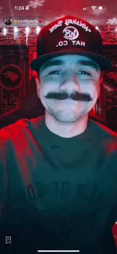 a man with a mustache wears a hat that says lordpunchy on it