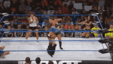two women are wrestling in a ring with the word impact on the wall