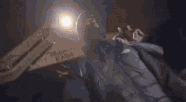 a man in a black jacket is laying on the ground in a room .