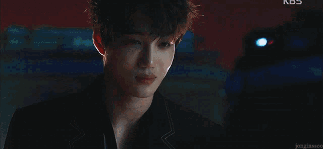 a close up of a person 's face with kbs written on the bottom right