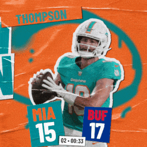 a dolphins football player named thompson holding a football