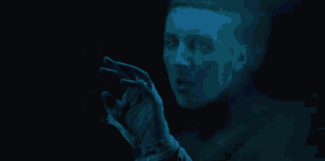 a man with his hand wrapped in bandages looks at something