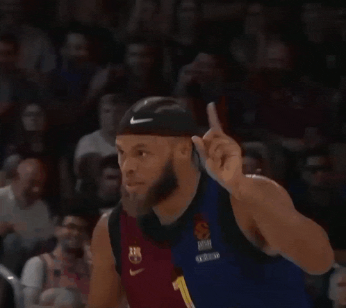 a basketball player wearing a number 1 jersey giving a thumbs up