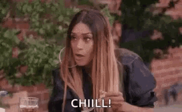 a woman is laughing and saying `` chill '' .