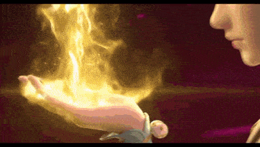 a woman is holding a fire in her hand .