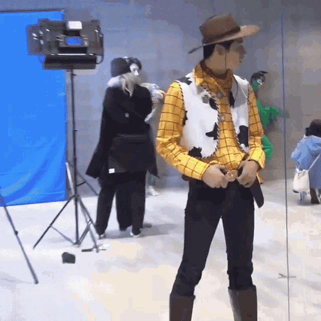 a man in a woody costume is standing in front of a camera