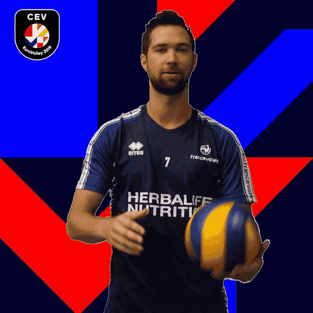 a man in a herbali nutrition jersey is holding a ball