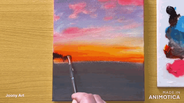 a person is painting a sunset with a brush on a canvas made in animatica