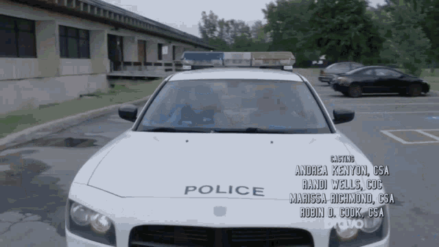a police car is parked in a parking lot with bravo written on the bottom