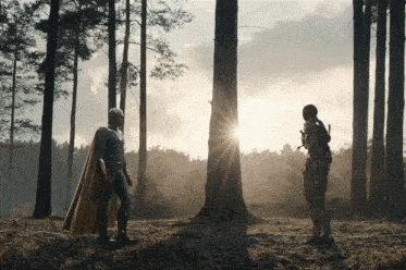 a man in a cape stands next to another man in a suit