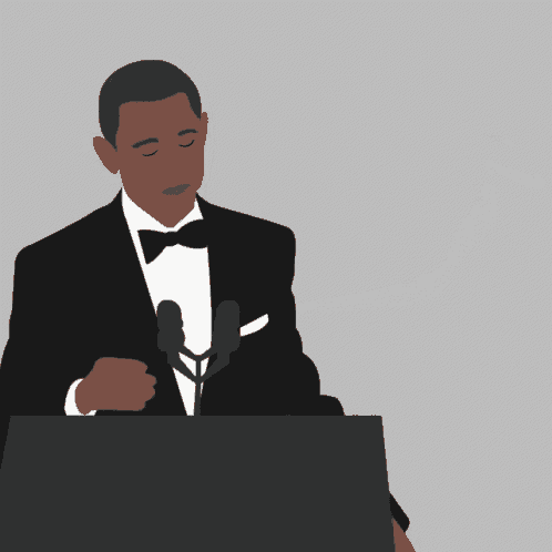 a man in a suit is holding a microphone in his hand