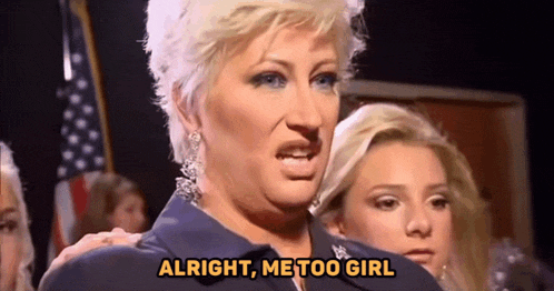 a woman is standing in front of a group of people and says `` alright , me too girl '' .