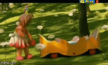 a girl in a pink dress is standing next to a yellow toy car in a field .