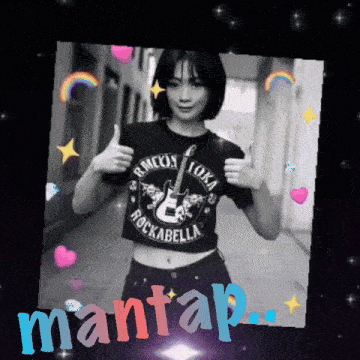 a woman wearing a rockabella t-shirt gives a thumbs up