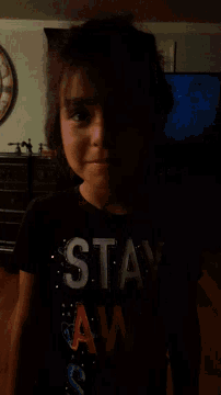 a boy wearing a black shirt that says stan