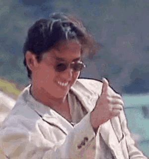 a man wearing sunglasses is giving a thumbs up .