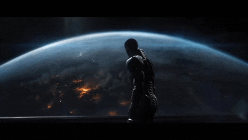 a man in a space suit stands in front of a blue planet