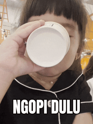 a girl drinking from a cup with the words ngopi dulu below her