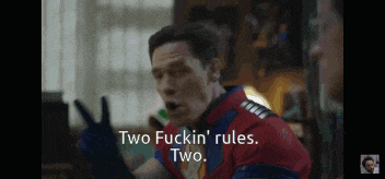 a man in a superhero outfit says two fuckin ' rules two