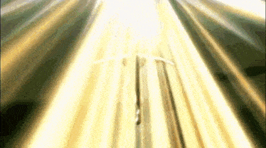 a person is holding a sword in front of a beam of light coming from the sky .