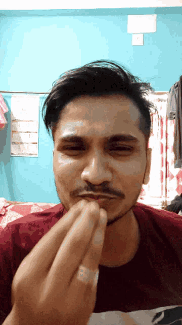 a man with a ring on his finger makes a funny face
