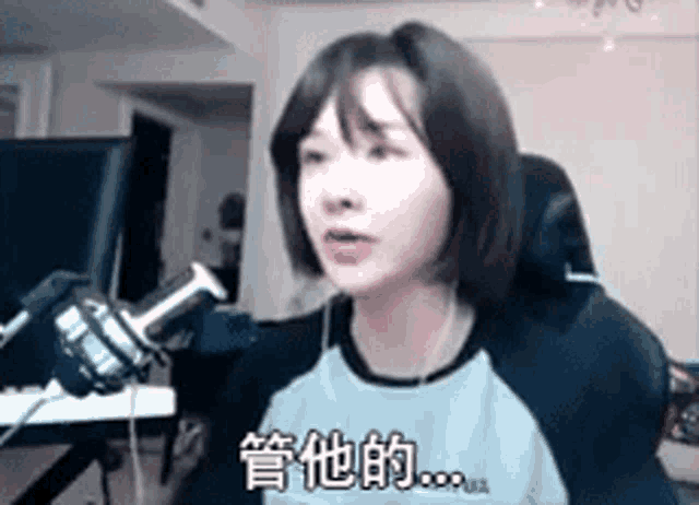 a woman is sitting in a chair in front of a microphone .