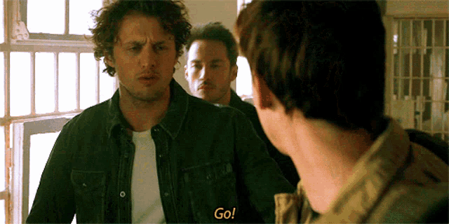 a man in a denim jacket says " go "