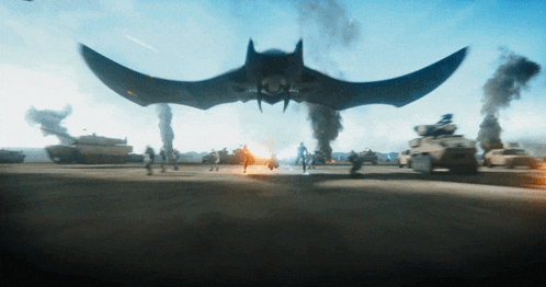 a large bat is flying over a military base with smoke coming out of it