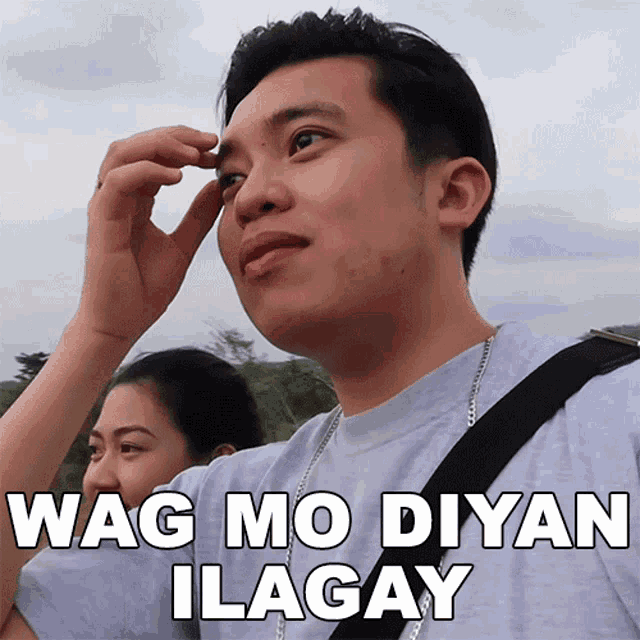 a man with a woman behind him has the words wag mo diyan ilagay written on his face