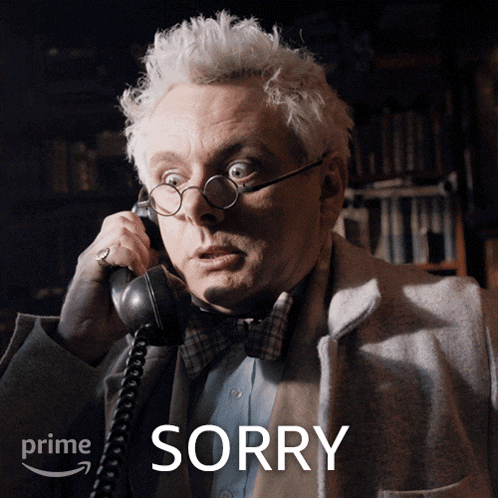 a man wearing glasses and a bow tie is talking on a telephone with the word sorry behind him