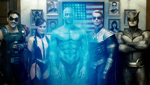 a group of superheros are posing for a picture with an american flag in the background