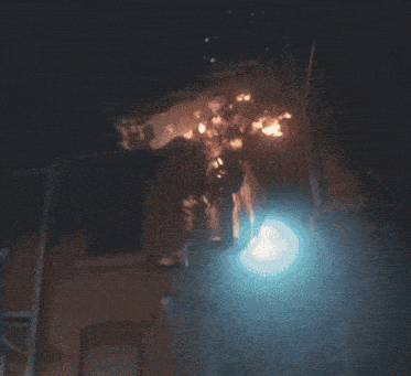 a man is standing on a balcony with his head on a box
