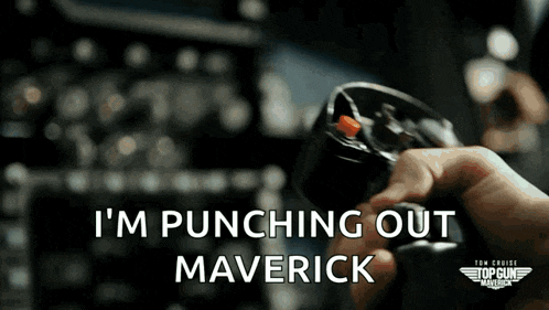 a person holding a steering wheel with the words " i 'm punching out maverick " written on it