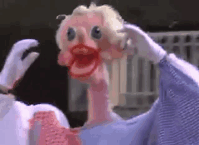 a cartoon character with a long neck and a big mouth is holding his head .